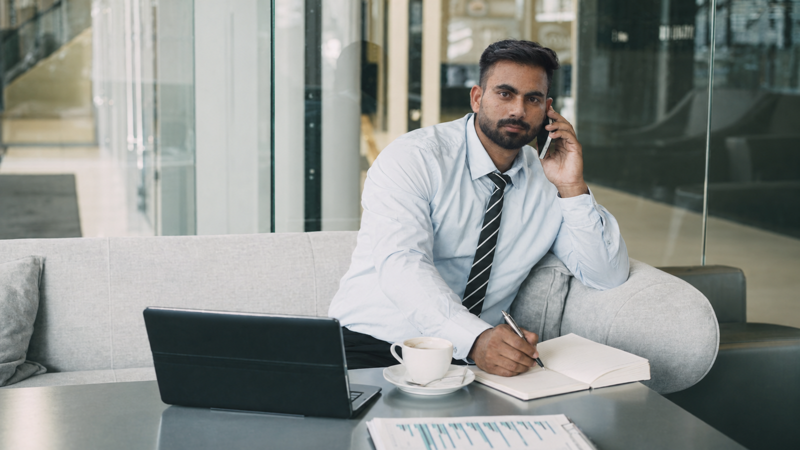 Business owner on a call, taking notes